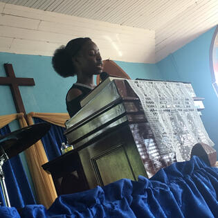 Youth Vice President, Brianna Frater leading in prayer